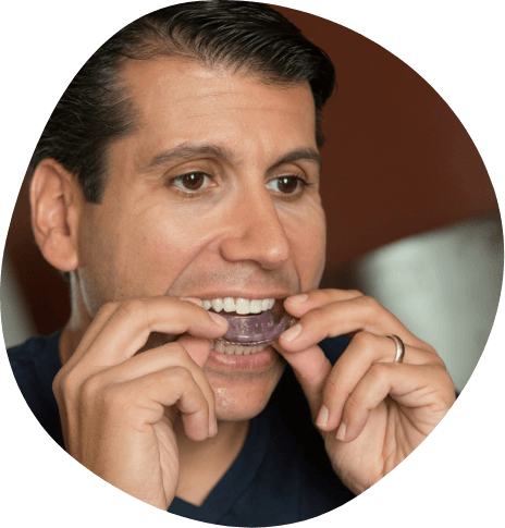 Man placing an oral appliance in his mouth