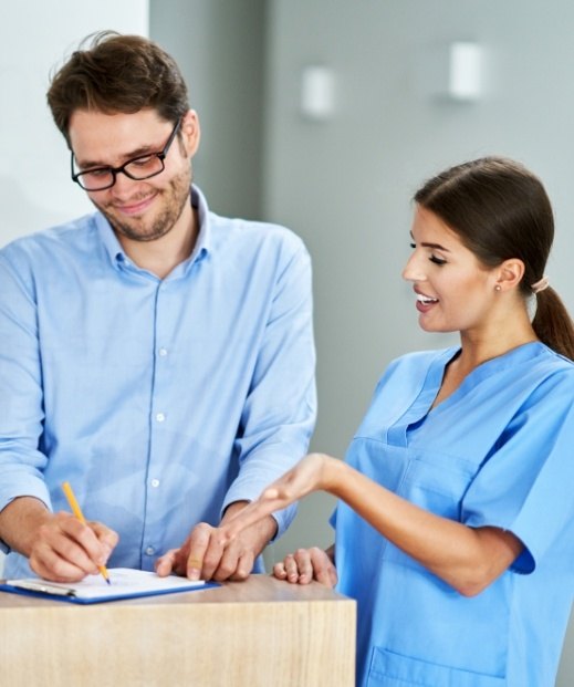 Man signing form for insurance for sleep apnea and sleep disorder treatment in Frisco
