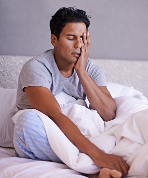 Man with obstructive sleep apnea in Frisco lying awake in bed