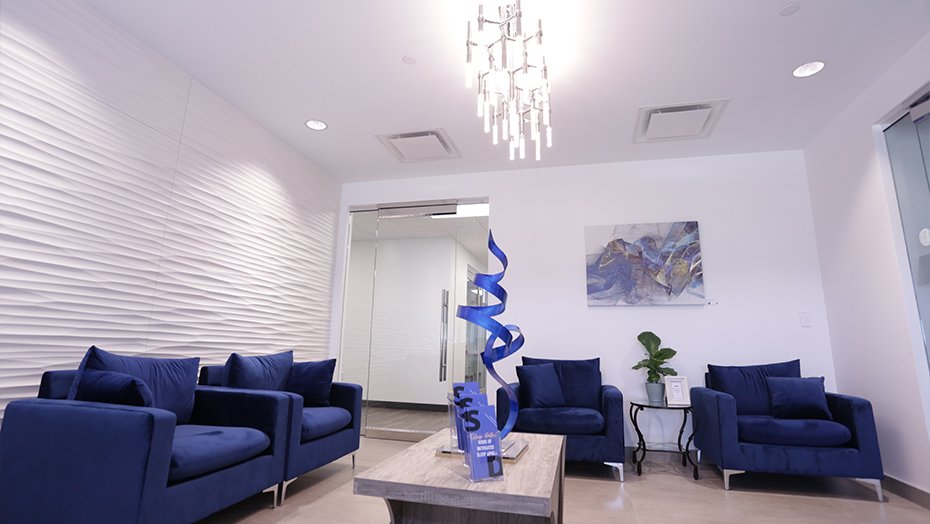 Consultation room with several blue chairs and small chandelier