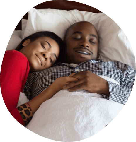 Man and woman sleeping soundly after oral appliance therapy in Frisco