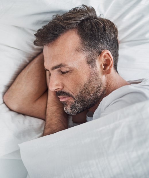 Man sleeping soundly after sleep apnea treatment in Frisco