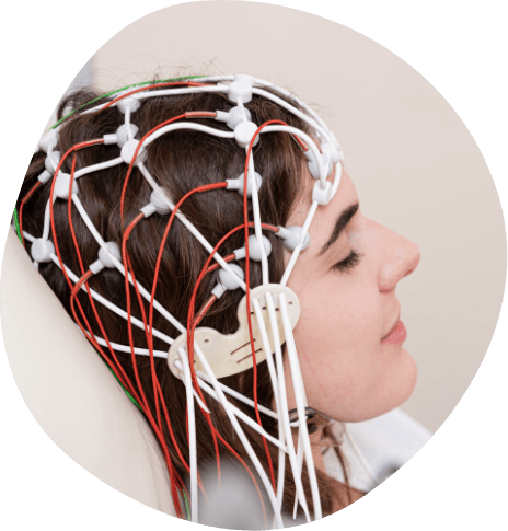Woman with several electrodes and wires across the top of her head