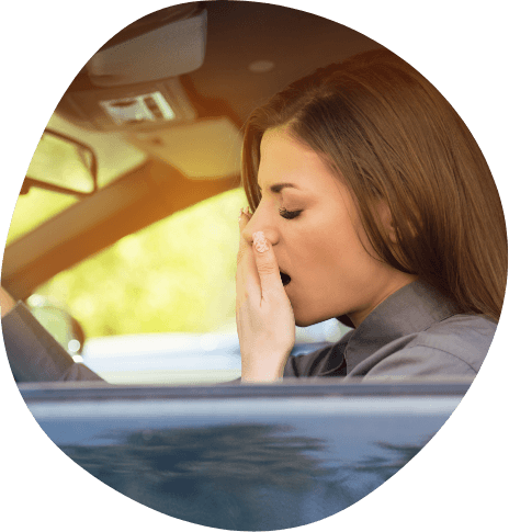 Woman yawning while driving