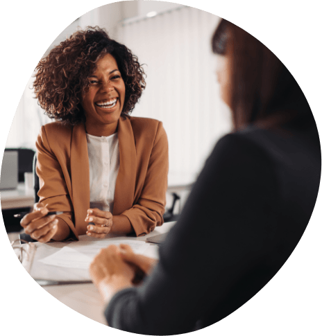 Two woman talking to each other from across a desk