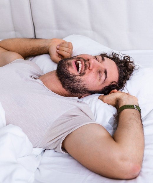Man waking up feeling refreshed after sleep disorder treatment in Frisco