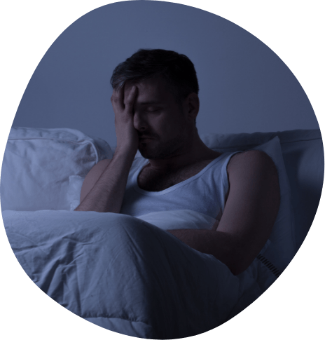 Frustrated man lying awake in bed