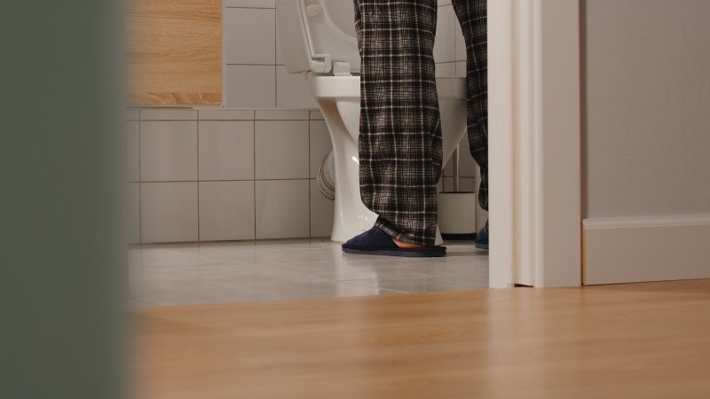 man using the bathroom at night