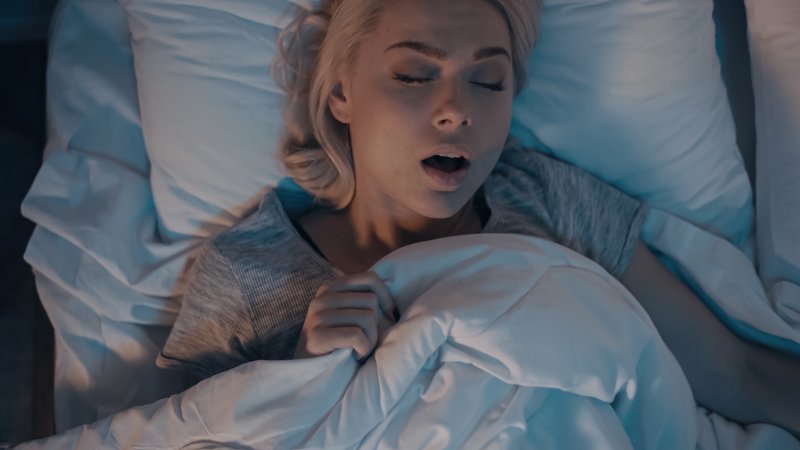 woman asleep in bed and snoring